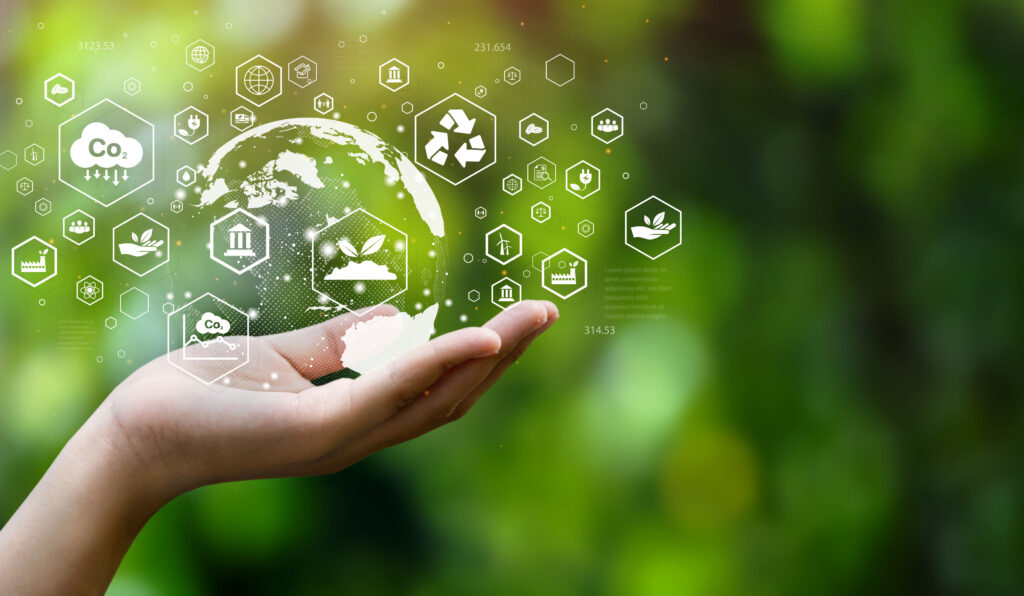 A hand holding a digital globe surrounded by eco-friendly icons, symbolizing sustainability and innovation.
